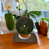Hand carved New Zealand Marsden Jade Disc with Greywacke stand sculpture. Hand carved here in New Zealand by Ric Moor. This is a 'one only' sculpture, a beautiful display piece.